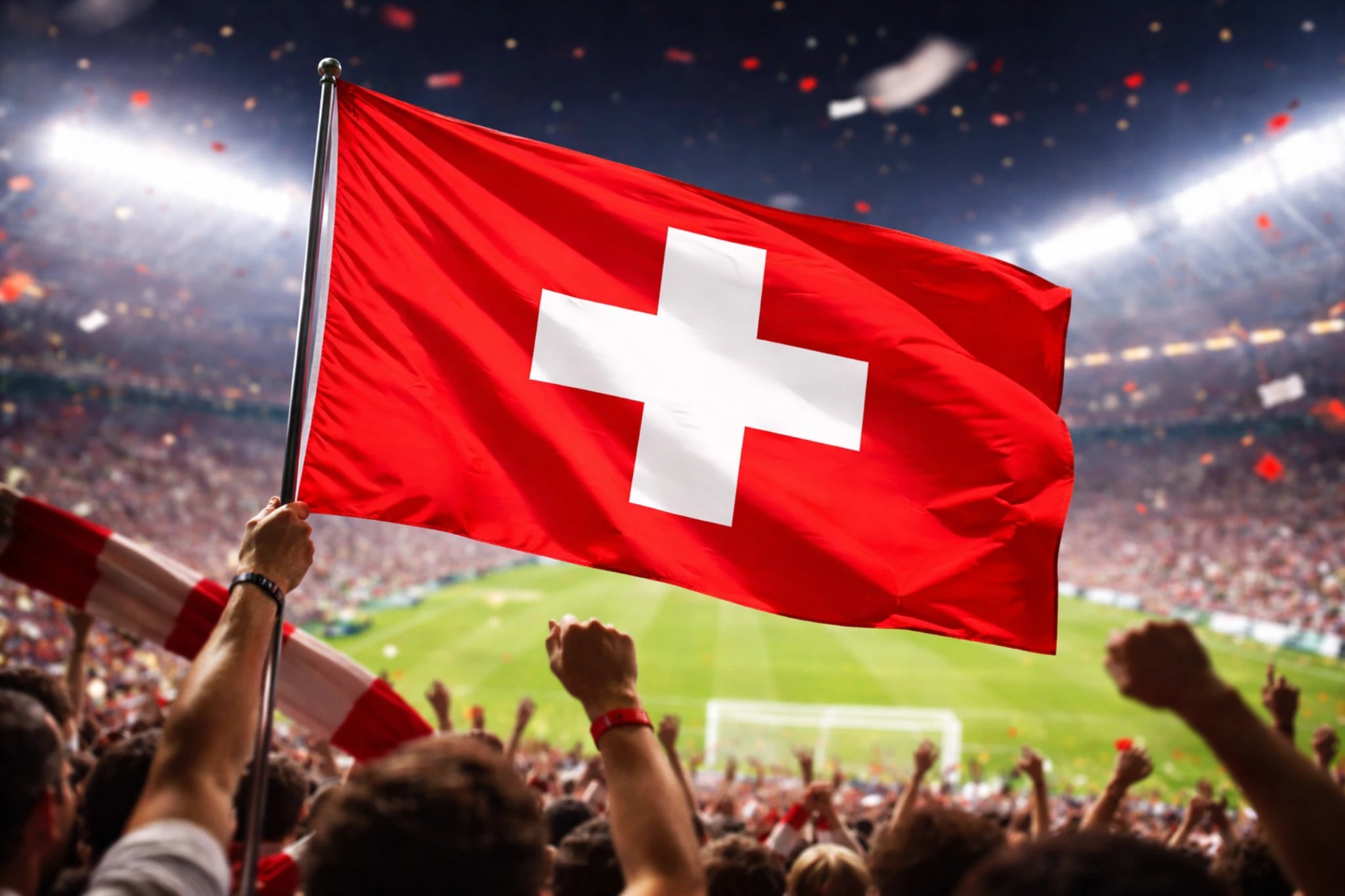 Fussball Veranstaltung mit wehender Schweiz Fahne in der Fankurve.